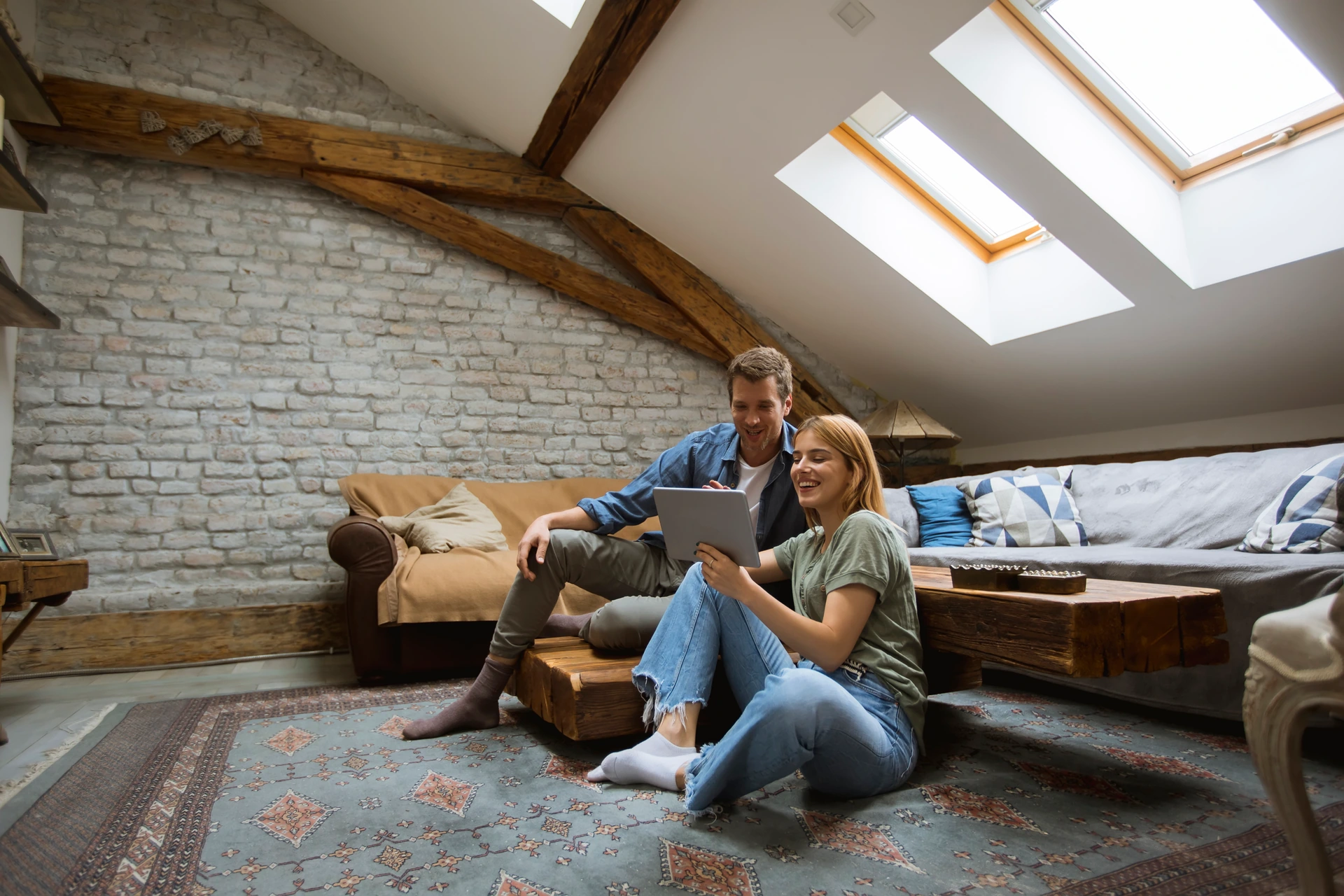 Lofts and Retrofits - young-couple-using-tablet-sitting-on-the-floor-at-2025-02-21-02-46-55-utc